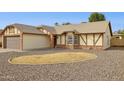 Single-story home features gravel landscaping and a large window with white horizontal blinds at 510 S Kenwood Ln, Chandler, AZ 85226