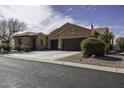 Charming single-story home featuring a three-car garage, tile roof and desert landscaping at 5450 N Globe Dr, Eloy, AZ 85131