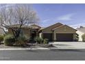 Charming single-story home featuring a three-car garage, desert landscaping and front stone entry at 5450 N Globe Dr, Eloy, AZ 85131