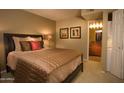 Cozy bedroom featuring a comfortable bed with warm lighting and an attached bathroom at 5877 N Granite Reef Rd # 2243, Scottsdale, AZ 85250