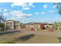 Attractive home exterior with desert landscaping, three-car garage, and solar panels for energy efficiency at 7662 W Artemisa Ave, Peoria, AZ 85383