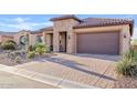 Paver driveway leading to the garage of the house at 7717 W Noble Prairie Way, Florence, AZ 85132