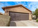 Home's two car garage, ample parking, and well-maintained landscaping enhance curb appeal at 7946 W Sonoma Way, Florence, AZ 85132