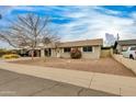 A cozy single-story house boasting a well-maintained front yard with desert landscaping and a covered carport at 8608 E Vernon Ave, Scottsdale, AZ 85257