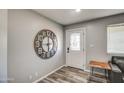 Inviting entryway with hardwood-style floors, designer clock, and decorative glass door at 901 W Parkway Blvd, Tempe, AZ 85281