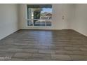 Clean, freshly painted living room with hardwood floors and a bright view through the window at 9023 N 18Th Ave, Phoenix, AZ 85021