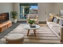 Bright living room with neutral decor, stylish rug, and view to the front yard at 9023 N 18Th Ave, Phoenix, AZ 85021