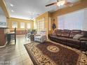 Inviting living room with tile floors, comfortable seating, and a ceiling fan for added comfort at 15240 N 142Nd Ave # 2102, Surprise, AZ 85379