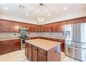 Gourmet kitchen with stainless steel appliances, center island, and custom cabinetry at 1737 E Azalea Dr, Gilbert, AZ 85298