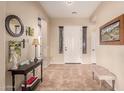 Welcoming entryway with neutral walls, tile floors, and a charming decorative table at 17857 W Desert View Ln, Goodyear, AZ 85338