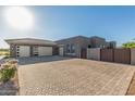 Wide paved driveway leading to a modern three-car garage, offering ample parking space at 19912 E Natalie Way, Queen Creek, AZ 85142