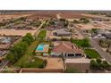 Expansive aerial view of a house with a refreshing pool, well-manicured lawn, and an inviting outdoor space at 21442 E Excelsior Ave, Queen Creek, AZ 85142