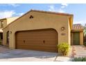 A beautiful home with a two-car garage, desert landscaping, and warm exterior lighting at 227 E Carob Dr, Chandler, AZ 85286
