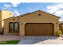 A lovely home with a two-car garage, desert landscaping, and elegant windows at 227 E Carob Dr, Chandler, AZ 85286