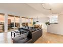 Open living space featuring tiled floors, a black leather sofa, and city views from the balcony at 2323 N Central Ave # 1902, Phoenix, AZ 85004