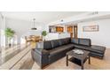 Bright living area with a large black sofa, tile flooring, and an open view to the dining area at 2323 N Central Ave # 1902, Phoenix, AZ 85004