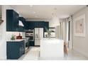 Bright kitchen showcases an island with a white countertop and open shelving, stainless appliances, and blue cabinets at 2393 W Mariposa St, Chandler, AZ 85224