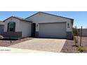 Well-maintained exterior showcasing a charming home with a paved driveway and low maintenance landscaping at 24369 W La Salle St, Buckeye, AZ 85326