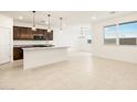 Bright kitchen with a large island, granite countertops, and modern stainless steel appliances at 24369 W La Salle St, Buckeye, AZ 85326