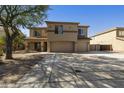 Two-story home boasts a three-car garage, desert landscaping, and neutral stucco exterior at 3423 E Superior Rd, San Tan Valley, AZ 85143