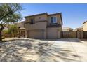 Two-story home boasts a three-car garage, desert landscaping, and neutral stucco exterior at 3423 E Superior Rd, San Tan Valley, AZ 85143