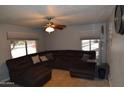 A comfortable living room features tile floors, a ceiling fan, and a large sectional sofa at 3708 W Redfield Rd, Phoenix, AZ 85053