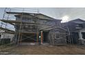 Home under construction, shows the exterior framing, siding, and windows, with scaffolding around the property at 37713 N Cowboy Ln, San Tan Valley, AZ 85140