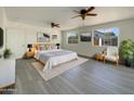 Serene main bedroom boasts ample space, neutral tones, ceiling fans, and picturesque windows, offering a relaxing retreat at 470 S Daley --, Mesa, AZ 85204