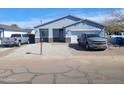 Exterior daytime view of the home, showcasing its grey facade, landscaping, and convenient two-car garage at 4835 S 35Th Dr, Phoenix, AZ 85041