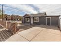 Charming single-story home features a covered entry, gray stucco, white trim, and spacious driveway at 501 W Romley Ave, Phoenix, AZ 85041