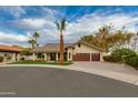 Attractive exterior showcasing lush landscaping, a three-car garage, and a welcoming entrance at 7721 N Via De La Montana --, Scottsdale, AZ 85258