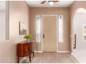 Inviting foyer featuring light wood-look tile floors, a console table, and an arched doorway at 10203 N Burris Rd, Casa Grande, AZ 85122