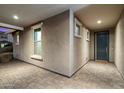 Welcoming covered front porch with stone pavers, offering a view of the home's entrance and windows at 10702 E Sheffield Dr, Mesa, AZ 85212