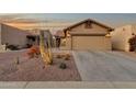 Attractive single-story home boasting a spacious driveway and desert landscaping at 10758 E Peralta Canyon Dr, Gold Canyon, AZ 85118