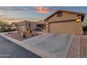 Well-maintained home featuring a neutral palette, desert landscaping, and an attached garage at 10758 E Peralta Canyon Dr, Gold Canyon, AZ 85118