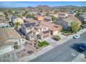 Aerial view of home featuring desert landscaping, solar panels, tile roof and mountain views at 10840 W Saddlehorn Rd, Peoria, AZ 85383