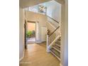 Grand foyer with high ceilings, tiled floor, staircase and natural light from open courtyard at 11656 N 135Th Pl, Scottsdale, AZ 85259