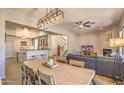 Spacious living space featuring an open floor plan, modern lighting, and seamless flow to the kitchen at 11656 N 135Th Pl, Scottsdale, AZ 85259