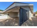 Modern carport featuring decorative brick accent wall and space for vehicle parking at 1206 E Loyola Dr, Tempe, AZ 85282