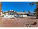 Charming single-story home featuring desert landscaping, a brick accent wall, and a private carport at 1206 E Loyola Dr, Tempe, AZ 85282