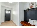 Inviting foyer features wood-look tile flooring, black accents and a convenient bench at 1206 E Loyola Dr, Tempe, AZ 85282