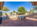 Private backyard with a large patio, seating area, mature trees and desert landscaping at 12601 S Tonto Ct, Phoenix, AZ 85044