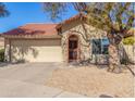 Charming single-story home featuring a terra cotta tile roof and a two-car garage at 12601 S Tonto Ct, Phoenix, AZ 85044