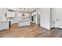 Bright kitchen featuring white cabinets, quartz countertops, stainless steel appliances, and a large island at 13386 W Eagle Feather Rd, Peoria, AZ 85383