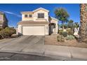 Two-story home featuring a two-car garage, neutral color palette, and low maintenance landscaping at 13556 W Desert Flower Dr, Goodyear, AZ 85395