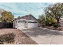 Charming one-story home featuring a two car garage, desert landscaping, and neutral colored stucco at 1431 S Nielson St, Gilbert, AZ 85296