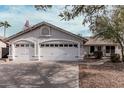 Charming one-story home featuring a two car garage, desert landscaping, and neutral colored stucco at 1431 S Nielson St, Gilbert, AZ 85296