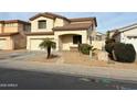 Charming two-story home featuring a well-maintained landscaped yard and attached garage at 14334 W Avalon Dr, Goodyear, AZ 85395