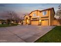 Spacious home featuring a long driveway and a three-car garage with a basketball hoop at 15011 N 45Th Pl, Phoenix, AZ 85032