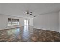 Bright living room area featuring a ceiling fan and ample sunlight at 15652 N 52Nd St, Scottsdale, AZ 85254